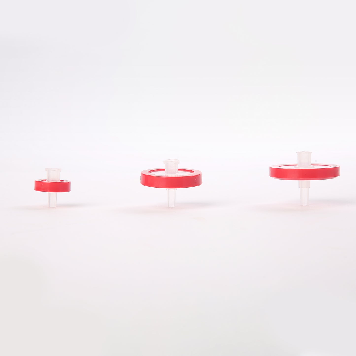 PTFE syringe filters in different sizes with red housings